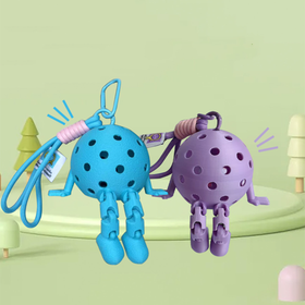 Two colorful keychains shaped like blue and purple jellyfish on a light green background.